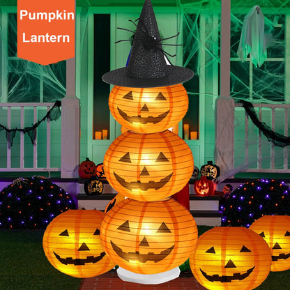Stack of glowing pumpkin lanterns with a witch hat on a Halloween-themed outdoor setting.