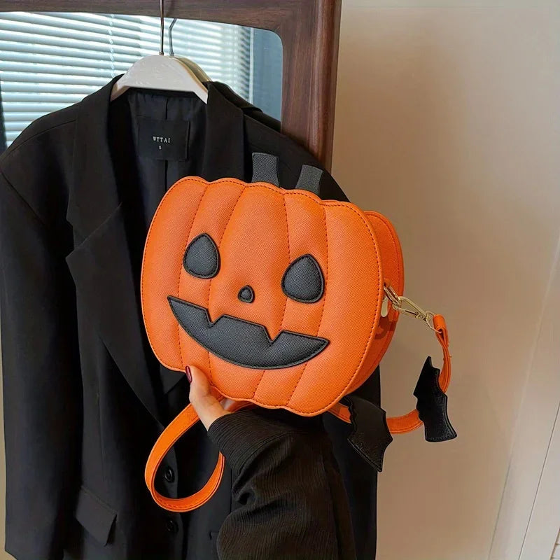 Pumpkin-shaped bag with a face design held in front of a black coat.