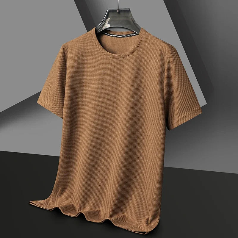 Brown t-shirt on a hanger against a gray background