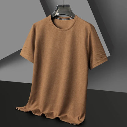 Brown t-shirt on a hanger against a gray background