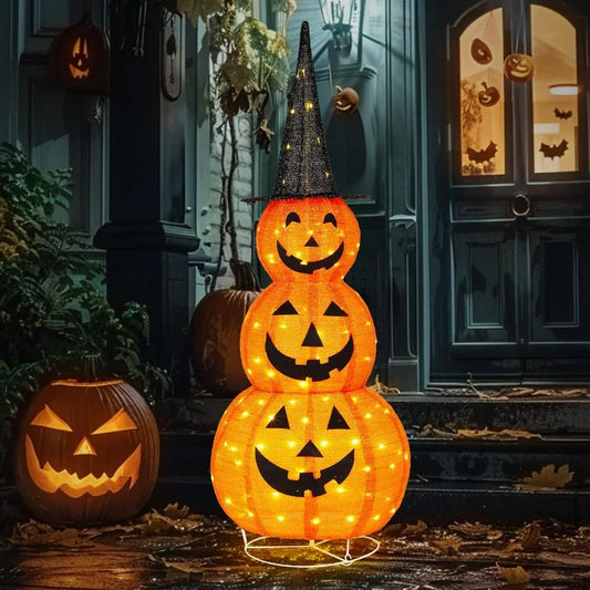 Stacked Halloween pumpkin lights with glowing faces in front of a door with carved pumpkins.