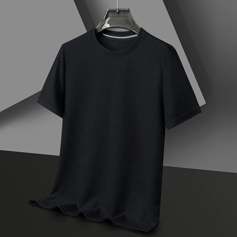 Black t-shirt on a hanger against a gray background