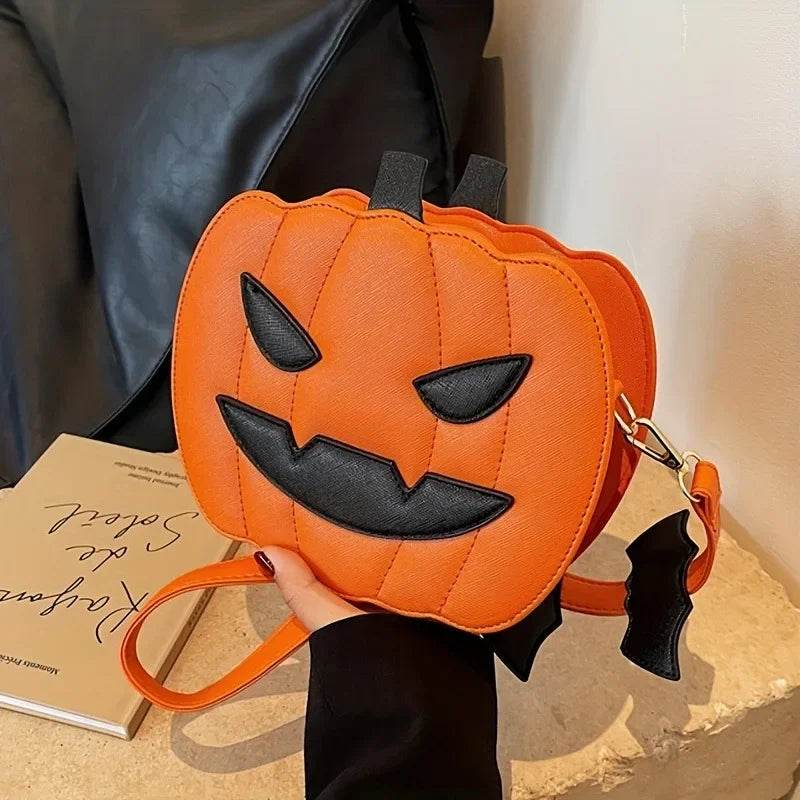 Pumpkin-shaped bag with a face design held by a hand on a textured surface.