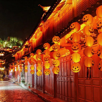 Decorative Halloween lanterns on a building exterior at night.
