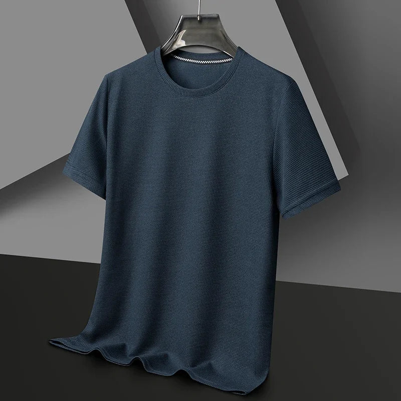 Blue t-shirt on a hanger against a gray background