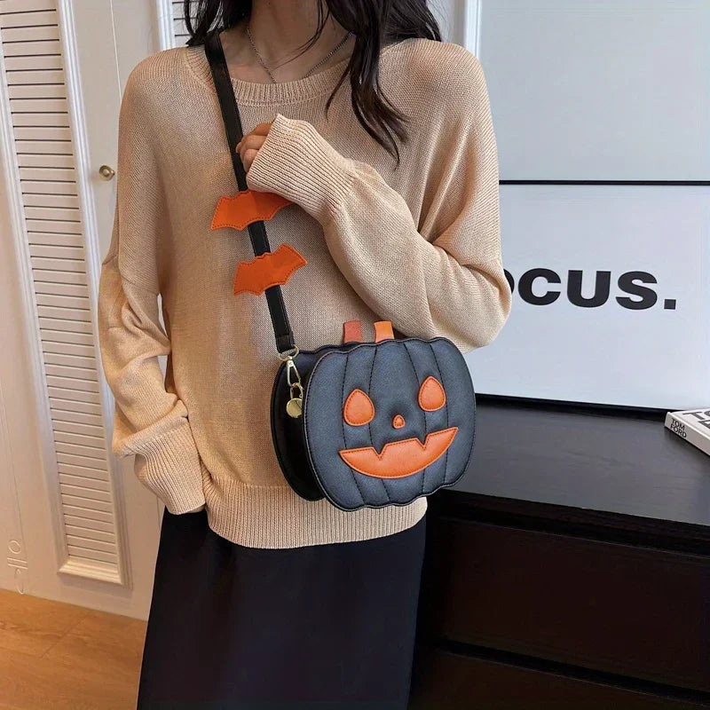 Person wearing a beige sweater with a pumpkin-shaped bag