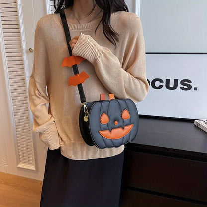 Person wearing a beige sweater with a pumpkin-shaped bag