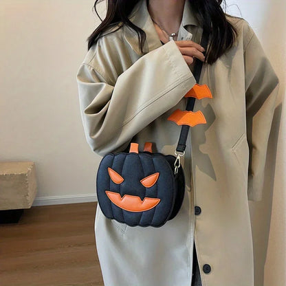 Person wearing a beige coat holding a black pumpkin-shaped bag with orange accents.